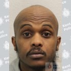 Image of Khalid Hashi, bald with a moustache and slight beard.