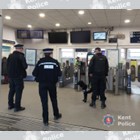 A group of police officers standing on a train station concourse