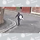 Man holding objects on a street
