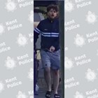 A man walking down a street with a bike