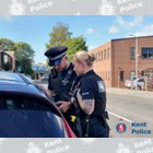 Officers checking car occupants.